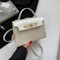 Elegant cream white top handle crossbody bag with structured design and gold metal buckle - White