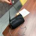 Chic black crystal barrel bag with silver chain and wide leather strap in variant black - Black