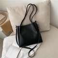 Minimalist black matte faux leather tote bag with dual straps and golden hardware buckles - Black