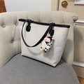 Minimalist cream woven tote bag with black leather trim and plush doll accessory - White With Pendant