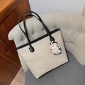 Canvas tote bag in beige with black handles and a small plush cow keychain charm - Beige With Pendant