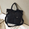 Black canvas tote bag with double pockets and sport tag in a minimalist style - Black