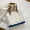 Borsa tote minimalista in tela bianca e blu con manici marroni e tasca frontale con zip - Bianco