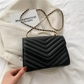 Classic black quilted crossbody bag with gold chain strap on white tweed fabric - Black