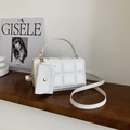 Elegant white quilted checkered handbag with matching pouch on a dark wooden surface - White