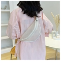 Detail view of a semi-transparent cream fanny pack with silver moon-shaped metallic studs - White