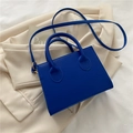 Klein blue mini handbag with leather texture and matching shoulder strap on beige blazer - Blue