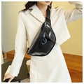 Glossy black patent leather belt bag with silver zipper shown on a model - Black