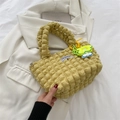Yellow popcorn texture handbag with fashion label and floral charm in 45-degree view - With Pendant / Yellow