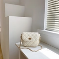 Quilted cream crossbody saddle bag with gold chain strap and elegant turn-lock closure - Off White