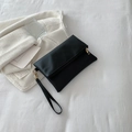 Minimalist black PU leather clutch with golden zipper and detachable wrist strap - Black