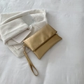Elegant champagne gold metallic PU clutch bag with wrist strap and fold-over zipper design - Gold
