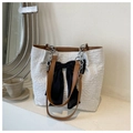 Detail of cream tote bag with elegant pleats, brown handle and black bow decoration - Brown