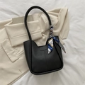 Minimalist black leather tote bag featuring a chic printed silk scarf on the slim handle - Black