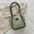 Chic light green leather tote with dark trim and decorative silk scarf detail - Green