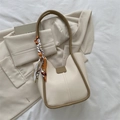 Minimalist off-white underarm bag with dark brown trim and decorative printed silk scarf - White