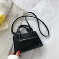 Minimalist black trapezoid handbag with dual handles and long tassel zipper details - Black