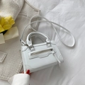 Mini white crossbody bag with long zipper pulls and a round handle on white fabric - White
