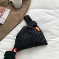 Retro black corduroy tote bag featuring a knot handle and cute orange carrot charm - Black