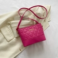 Quilted magenta crossbody bag with gold accents on white blazer background - Rose Red