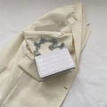 Elegant white crocodile embossed square bag with a bold silver chain on a beige blazer - White