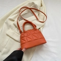 Quilted mini handbag in bright orange with triangular stitching and top handle - Orange
