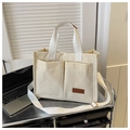 Detail of corduroy tote bag showing double front pockets and brown fashion leather label - Off White