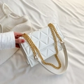 Elegant white quilted crossbody bag with gold chain strap held by a person - White