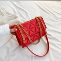 Quilted red shoulder bag with geometric triangle stitching and golden chain strap - Red