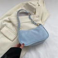 Light blue baguette shoulder bag featuring rectangular embossing and gold chain detail - Blue
