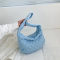 Close-up of light blue quilted nylon tote bag with rhombus stitching and soft texture - Blue
