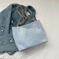 Light blue tote bag with textured finish and khaki leather straps on denim - Blue