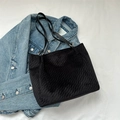 Black velvet tote bag with checkered embossing and thin leather straps on denim - Black