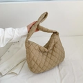 Detailed view of khaki quilted tote bag with unique woven shoulder strap design - Khaki