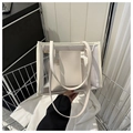 Detail of transparent PVC tote bag with cream leather trim and inner pouch for summer - White