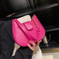 Vibrant pink crescent shoulder bag with gold chain strap on a modern studio background - Rose Red