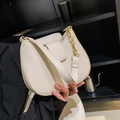 Chic off-white half-moon shoulder bag with gold chain strap in a modern lifestyle setting - Off White