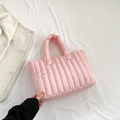 Pink quilted tote bag with vertical padded patterns and top handles in minimalist style - Pink