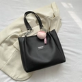 Black matte leather tote bag with chain strap and a pink peach plush charm accent - With Pendant / Black