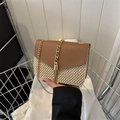Chic straw woven crossbody bag with brown leather flap and stylish metal tassel detail - Brown