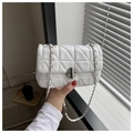 Detailed close-up of white geometric quilted faux leather bag with silver chain strap - White