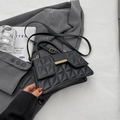 Minimalist black quilted crossbody bag with geometric stitching and gold metal clasp - Black