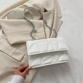 White quilted geometric shoulder bag with silver metal chain on beige blazer jacket - White