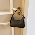 Minimalist black leather hobo shoulder bag with sleek gold zipper and crescent shape - Black