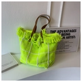 Macro detail of fluorescent green woven tote bag with white checks and fringe trim - Neon Green