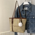 Beige woven straw tote bag with brown leather handles and decorative plush charm - With Pendant / Brown