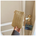 Detail einer handgehaltenen beigen Stroh-Handytasche mit goldenem Druckknopf und Gurt - Khaki