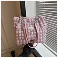 Detail of pink bubble texture tote bag with silver chain strap and fashion label - Pink