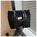 Detail of black waffle pattern tote bag with pearl and floral metal chain accessory - Black