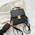 Mini black leather backpack with gold metal clasp on off-white suit blazer background - Black without Pendant